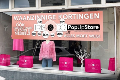 etalage met roze tassen en mannequin met roze trui van iris en co